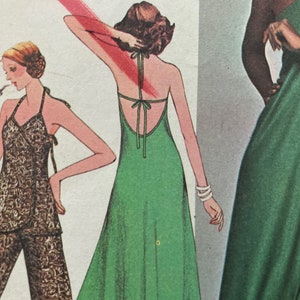 May include: Three women wearing different styles of dresses. The woman on the left is wearing a brown and black patterned dress with a halter top. The woman in the centre is wearing a green halter dress with a low back. The woman on the right is wearing a green dress with a V-neck.