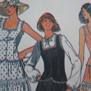 May include: Three women's fashion illustrations featuring different styles of sleeveless tops with lace trim. The tops are paired with skirts. One woman is wearing a hat.