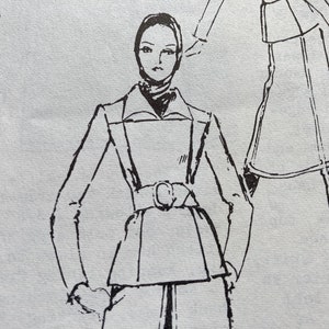 May include: A black and white line drawing of a woman wearing a long-sleeved jacket with a belt and a skirt. The drawing is on a light blue background. The text "TURNABLE FOR EXCHANGE PATTERN NOTE SIZE STAMPED IN RED" is visible in the upper left corner.