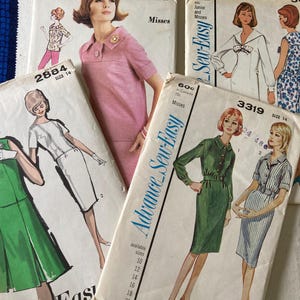 May include: A collection of vintage sewing patterns featuring illustrations of women's dresses. The patterns are from the "Advance Sew-Easy" brand and include various sizes. The color palette includes pink, green, and white.