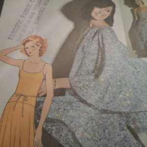 May include: Two women modelling dresses. The woman on the left is wearing a yellow sundress with a tie at the waist. The woman on the right is wearing a blue and white floral print dress with a ruffled neckline.