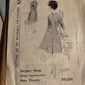 May include: A vintage sewing pattern for a dress, featuring a black and white illustration of a woman wearing a dress with a fitted bodice and a full skirt. The pattern is labelled "Jacques Heim" and "Suzy Perette" and has the number "NS-208".