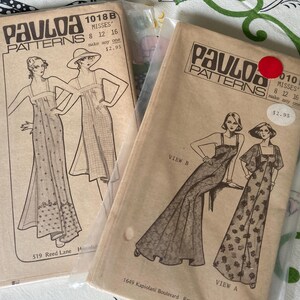 May include: Two tan paper sewing pattern envelopes by Paula Patterns, labeled 1018B and 010B. Each envelope features black line drawings of dresses, size information for 8, 12, and 16, and text including 519 Reed Lane and 1649 Kapiolani Boulevard.