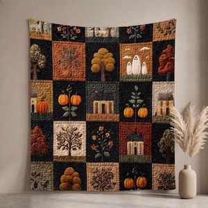 May include: A rectangular wall quilt featuring a grid of square panels with autumn-themed motifs including orange pumpkins, various trees, houses, and ghost figures. The quilt has a dark black background with a textured, quilted stitch pattern.