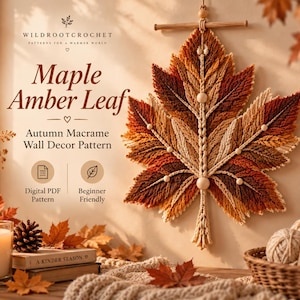 May include: A macrame wall hanging shaped like a large maple leaf in shades of amber, brown, and cream, suspended from a wooden dowel. The text reads Wildrootcrochet, Maple Amber Leaf, Autumn Macrame Wall Decor Pattern, Digital PDF Pattern.