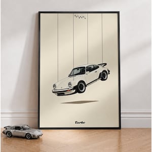 May include: A framed poster featuring a white sports car suspended by thin black vertical lines, resembling a marionette. The text "Hangedauto" appears at the top, and the word "turbo" is printed in black at the bottom on a cream background.