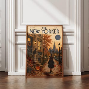 Peut inclure: Une impression encadrée de la couverture du magazine The New Yorker datée du 31 octobre 1955. L'illustration représente une rue urbaine en automne avec un enfant déguisé en sorcière marchant devant un immeuble, un chat noir et des citrouilles.