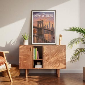 New York wall art featuring the Brooklyn Bridge and Manhattan skyline at sunset in warm peach, orange and lavender tones. The East River reflects the glowing city lights while a waterfront promenade and bench create a peaceful NYC scene. Textured vintage inspired artwork ideal for New York decor, Brooklyn wall art, Manhattan gallery walls, living rooms, bedrooms, offices and travel inspired interiors.