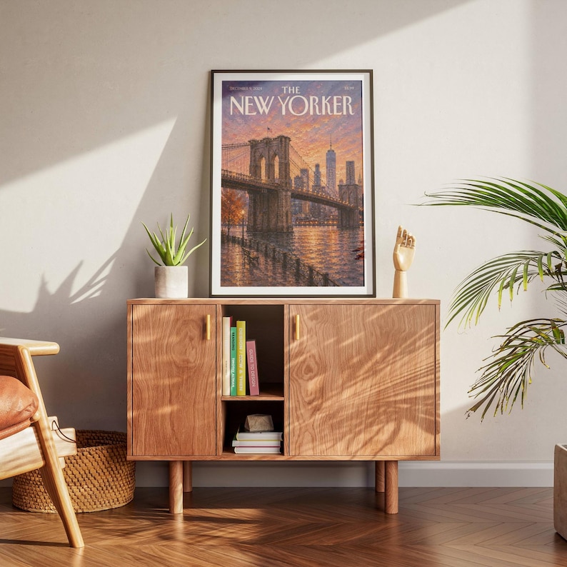 New York wall art featuring the Brooklyn Bridge and Manhattan skyline at sunset in warm peach, orange and lavender tones. The East River reflects the glowing city lights while a waterfront promenade and bench create a peaceful NYC scene. Textured vintage inspired artwork ideal for New York decor, Brooklyn wall art, Manhattan gallery walls, living rooms, bedrooms, offices and travel inspired interiors.