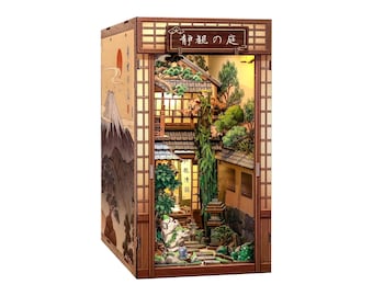 May include: A wooden book nook diorama featuring a Japanese garden scene with miniature trees, stone lanterns, and a building. The exterior side panel displays a mountain illustration. The top sign features the Japanese text "静観の庭".