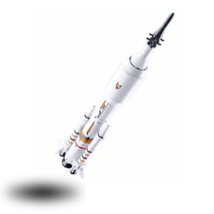 May include: A white model rocket featuring orange and black accents, with the number 735 printed on the side. The rocket has a pointed nose cone, a cylindrical main body, and four smaller booster rockets attached to the base with black engine nozzles.