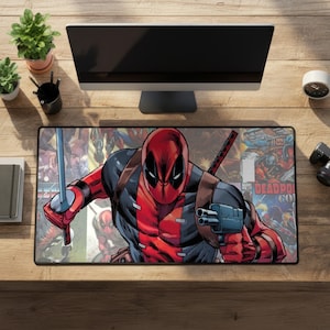 May include: A rectangular desk mat featuring a comic book illustration of the character Deadpool in a red and black suit, holding a sword in one hand and a handgun in the other, set against a collage of various Deadpool comic book cover art.