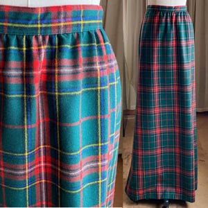 May include: A long, green plaid skirt with red, yellow, and blue accents. The skirt has an elastic waistband and a full length design. The plaid pattern is a classic design, suitable for various occasions.