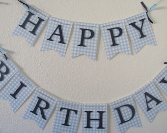 May include: A blue and white gingham banner with the words "Happy Birthday" in black letters.