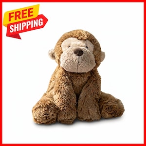 May include: A plush monkey toy with shaggy brown fur and a lighter beige face. The stuffed animal features a dark brown nose, small rounded ears, and long arms resting at its sides. The toy has a soft, textured appearance throughout.