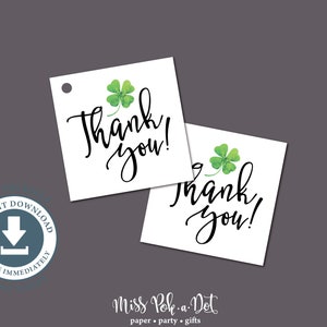 May include: Two white square tags with a green shamrock and the words "Thank you!" in black script. The tags are on a gray background. The image also includes a blue circle with the words "Instant Download" and "Receive Immediately".