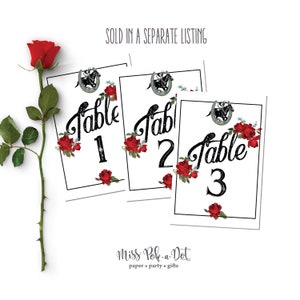 May include: White table number cards with black script reading "Table 1", "Table 2", and "Table 3". Each card is decorated with red roses and a horseshoe graphic. The words "SOLD IN A SEPARATE LISTING" are at the top.