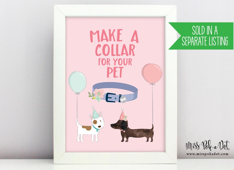 May include: A framed print with a pink background features the text "MAKE A COLLAR FOR YOUR PET." It includes illustrations of a blue collar, two dogs wearing party hats, and balloons. The print is in a white frame.