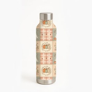 May include: A cylindrical metal water bottle with a silver cap and base. The body features a repeating patchwork pattern of cream, sage green, and soft orange squares decorated with illustrations of pumpkins, small stars, and leafy foliage.