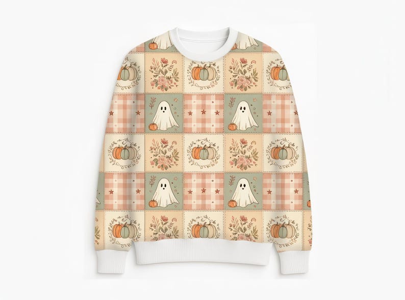 May include: A long-sleeve crewneck sweatshirt featuring a repeating patchwork pattern. The design includes alternating squares of white ghosts with orange pumpkins, floral arrangements, and a soft peach and white plaid with small star accents.