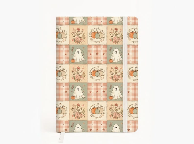 May include: A rectangular notebook featuring a repeating grid pattern of illustrations including white ghosts, orange and blue pumpkins, floral bouquets, and pink plaid squares. The notebook has a vertical white elastic band closure on the right side.
