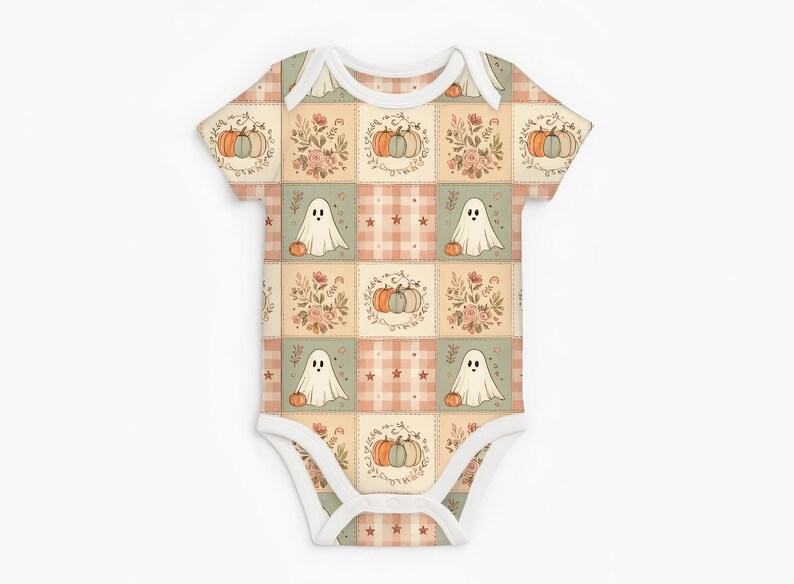 May include: A short-sleeved baby bodysuit featuring a patchwork pattern of alternating squares. The design includes illustrations of white ghosts, orange and blue pumpkins, floral arrangements, and small stars on a soft plaid background.