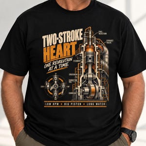 May include: A black t-shirt featuring a technical diagram of a two-stroke engine. The graphic includes the text "TWO-STROKE HEART ONE REVOLUTION AT A TIME" and "LOW RPM BIG PISTON LONG WATCH" with labels for fuel injection, exhaust valve, cylinder, crosshead, connecting rod, and crankshaft.