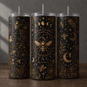 May include: Three black cylindrical tumblers with gold-colored bee, honeycomb, floral, and celestial patterns. The center tumbler features the text BEEWITCHED STACY and the Scorpio zodiac symbol. Each tumbler includes a silver-colored metal straw.