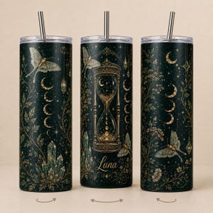 May include: Three cylindrical tumblers with metal straws, featuring a dark green background with gold celestial motifs, including an hourglass, moths, moon phases, and crystals. The center tumbler displays the name Luna in gold cursive script.