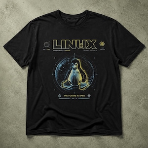 May include: A black short-sleeve t-shirt featuring a graphic print of the Linux penguin mascot centered within a circular technical diagram. The text LINUX appears at the top in yellow, with the phrase THE FUTURE IS OPEN printed below.