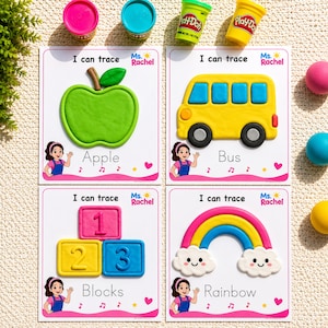 May include: Four white educational activity cards featuring Ms. Rachel branding and the text I can trace. The cards display moulded playdough shapes of a green apple, a yellow bus, numbered blocks, and a colourful rainbow with white clouds.