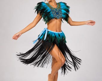 May include: A two-piece costume featuring a cropped top and a skirt. The top has blue and black feathers with a beaded neckline. The skirt has a blue and black feathered waistband with long, flowing black fringe that extends to the knees.