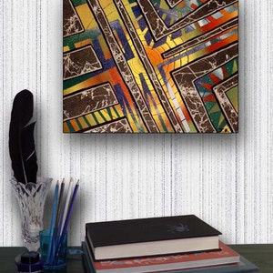 May include: Abstract painting with geometric shapes in shades of brown, yellow, green, blue, and orange. The painting has a textured surface and is framed in black.