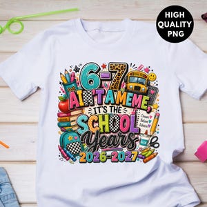 May include: A white t-shirt featuring a colorful graphic design with school supplies, a yellow bus, and the text 6-7 AIN'T A MEME IT'S THE SCHOOL YEARS 2026-2027. The print includes books, pencils, a backpack, and scissors in vibrant patterns.