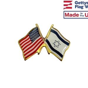 May include: A gold-colored pin with two crossed flags. The flag on the left is the American flag, and the flag on the right is the Israeli flag. The pin is made in the USA.