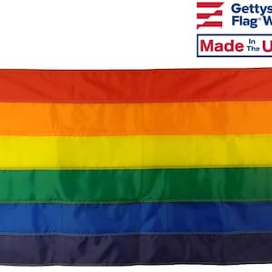 May include: A rainbow pride flag with six horizontal stripes in the colors red, orange, yellow, green, blue, and purple. The flag is made in the USA by Gettysburg Flag Works.