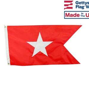 May include: A red flag with a white five-pointed star in the center. The flag is made of a lightweight fabric and has a white border. The flag is flown on a pole.