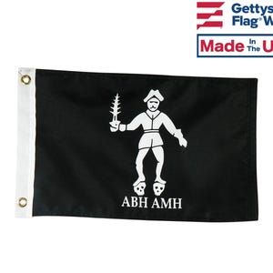 May include: A black pirate flag with a white skull and crossbones design. The flag features a white figure holding a sword and the text "ABH AMH".