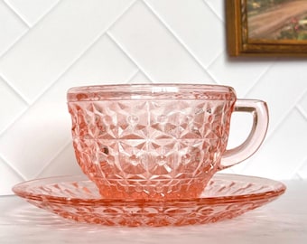 Jeannette Holiday “Buttons & Bows” Pink Depression-Style Glass Teacup and Saucer Set / Circa 1940s