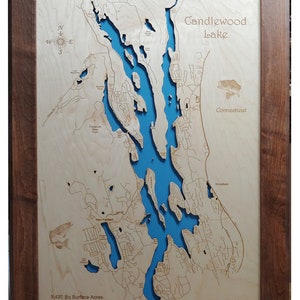 May include: Wooden framed map of Candlewood Lake, Connecticut, with a blue lake and detailed land features. The map includes text indicating the lake's dimensions: 5,420 sq acres, average depth 40 feet, max depth 90 feet, and max length 11 miles.