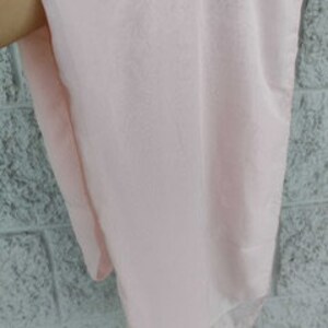 May include: A pale pink fabric swatch, showing the texture and color of the material.