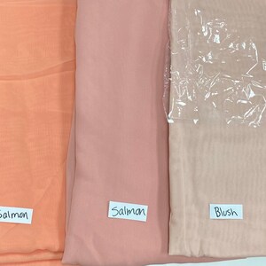 May include: Three swatches of sheer fabric in different shades of pink. The swatches are labeled "Salmon", "Salmon", and "Blush".