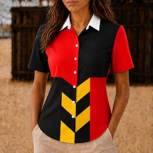 May include: A short-sleeve button-down shirt featuring a color-blocked design in red, black, and yellow with a white collar. The front panel displays a geometric chevron pattern in black and yellow, while the sleeves and sides are solid red and black.