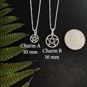 May include: Two silver pentacle necklaces on a black background. The smaller necklace has a 10 mm pentacle and the larger necklace has a 16 mm pentacle. Charm A 10 mm. Charm B 16 mm.