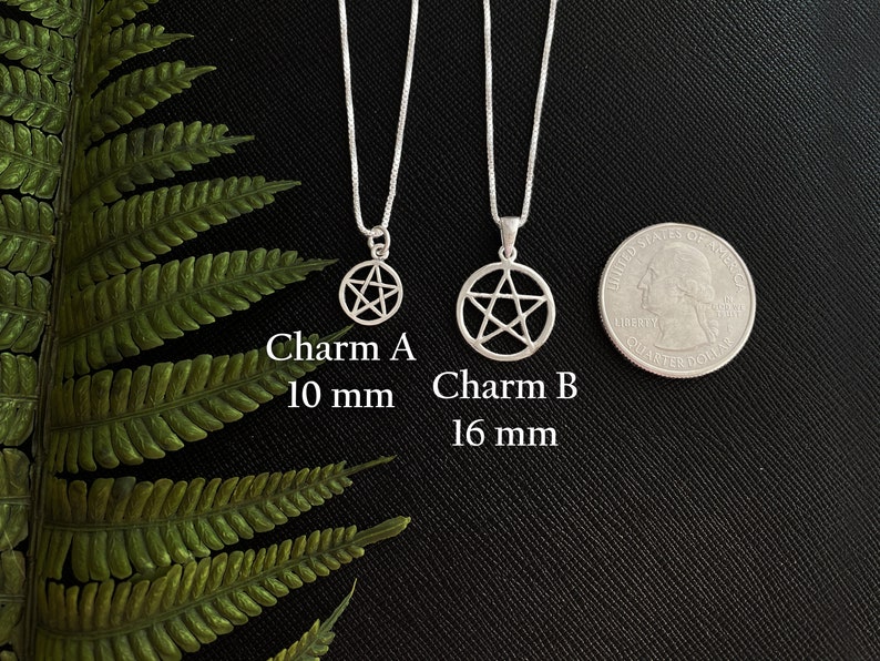 May include: Two silver pentacle necklaces on a black background. The smaller necklace has a 10 mm pentacle and the larger necklace has a 16 mm pentacle. Charm A 10 mm. Charm B 16 mm.