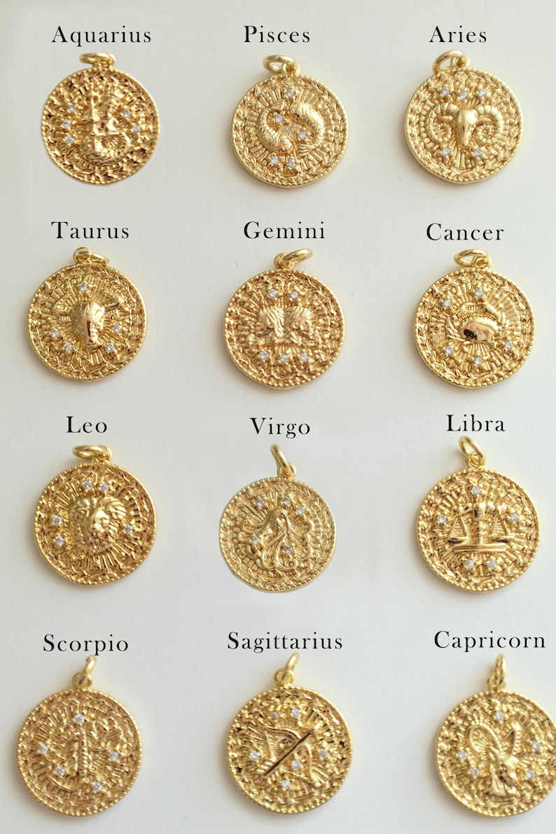 May include: Twelve gold zodiac pendants with white gemstones. Each pendant features a different zodiac sign, including Aquarius, Pisces, Aries, Taurus, Gemini, Cancer, Leo, Virgo, Libra, Scorpio, Sagittarius, and Capricorn.