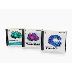 May include: Three software CD cases featuring Microsoft branding. The first is Mastering Microsoft Visual Basic with green blocks, the second is Microsoft Visual Basic Professional Edition with purple blocks, and the third is Microsoft Visual C++.