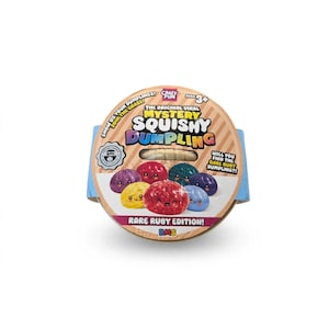May include: A round cardboard packaging for a Mystery Squishy Dumpling toy. The label features the text The Original Viral Mystery Squishy Dumpling, Rare Ruby Edition, and illustrations of colorful, smiling, round dumpling characters.