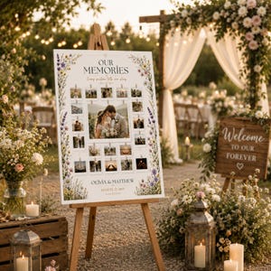 May include: A white rectangular wedding photo display board on a wooden easel featuring the text "OUR MEMORIES" and "OLIVIA & MATTHEW AUGUST 29, 2025". The board is decorated with colorful wildflower illustrations and holds multiple small square photographs.