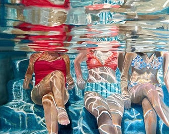 May include: Three people are sitting in a pool, their legs and torsos are visible above the water. The water is clear and blue, and the pool floor is tiled. The people are wearing swimsuits and are relaxed.